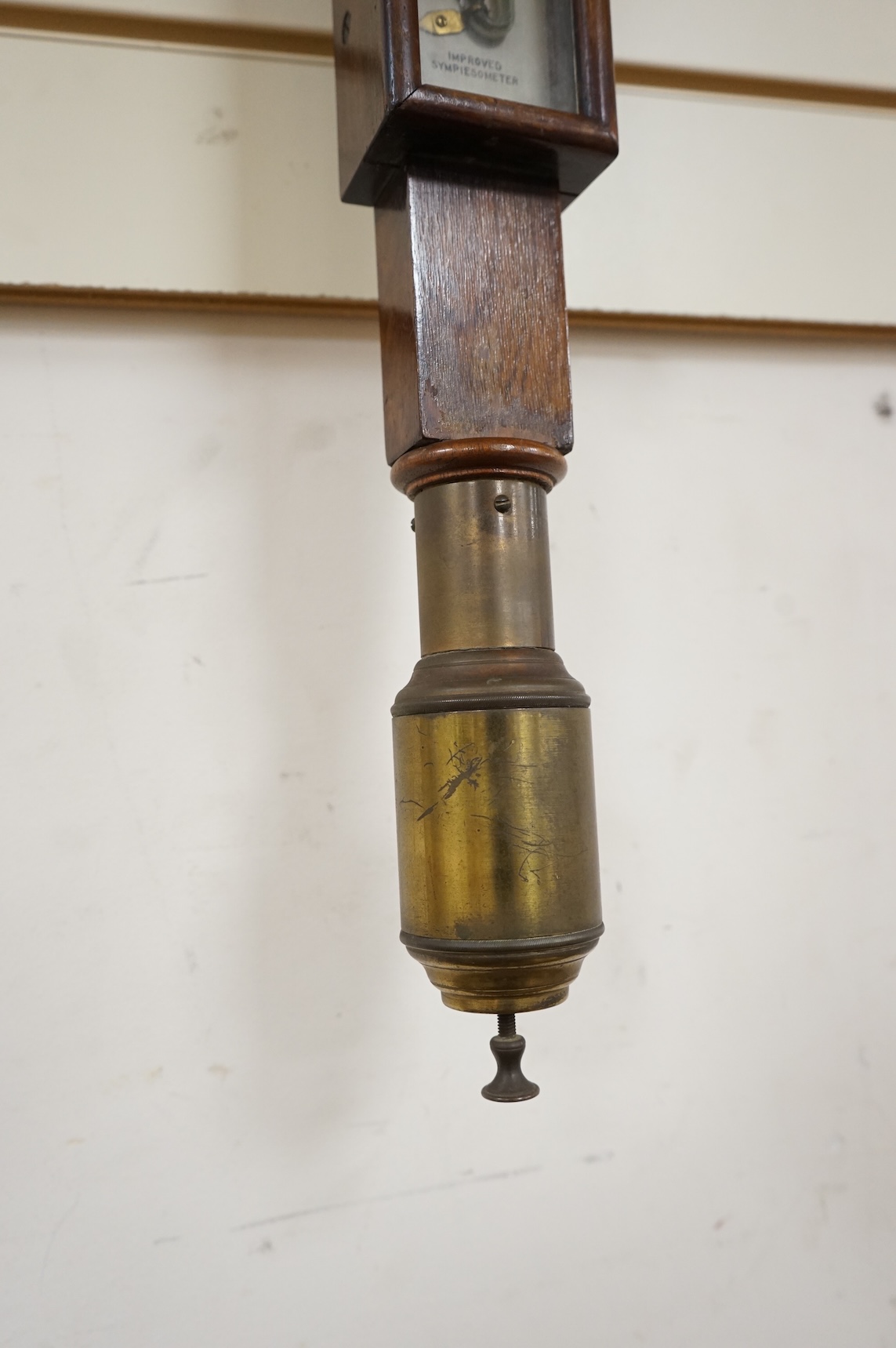 A 19th century oak marine stick barometer by Whyte Thomson, Glasgow, with ‘improved sympiesometer’ and thermometer to the front, with part of the brass gimbal holder still present, 96cm high, CITES Submission reference Y